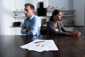 divorcing couple sitting in lawyers office